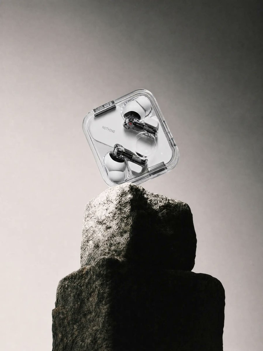 Transparent Earbuds on Stone Pedestal preview image