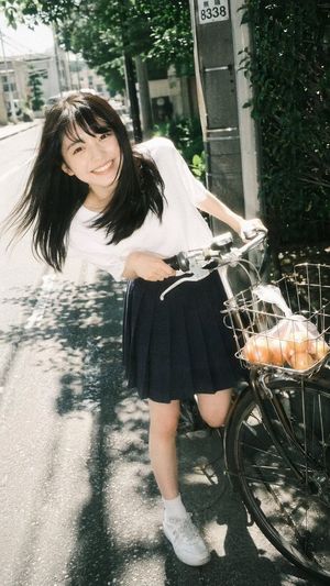 Retro film portrait of a girl riding a bicycle (preview image)